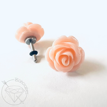 Load image into Gallery viewer, two delicate pink rose-shaped earrings with a silver post and a black rubber stopper.