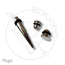 Load image into Gallery viewer, a collection of three metal piercing plugs, including a conical plug, a round plug, and a small round plug, arranged on a white background.
