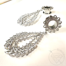 Load image into Gallery viewer, a pair of elegant silver earrings with intricate designs, including a large floral-shaped earring and a smaller, round earring.