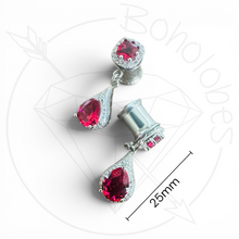 Load image into Gallery viewer, a pair of earrings with red gemstones, including a pair of dangling earrings and a matching earring post. The earrings are set in silver, and the image is described as a size 25mm in length.