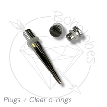 Load image into Gallery viewer, a set of metal piercing tools, including a sharp, pointed metal piece and two clear plastic caps, arranged on a white background.