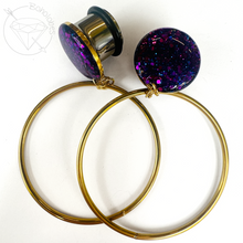 Load image into Gallery viewer, a pair of gold hoop earrings with purple glitter accents, as well as a silver earring stud.