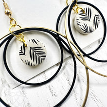 Load image into Gallery viewer, Black and gold leaf hoop dangle earrings