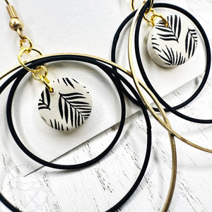 Black and gold leaf hoop dangle earrings