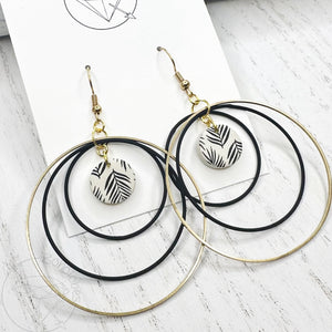 Black and gold leaf hoop dangle earrings