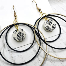 Load image into Gallery viewer, Black and gold leaf hoop dangle earrings