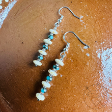 Load image into Gallery viewer, A pair of earrings with a row of small beads in various colors, including white, blue, and green, hanging from a hook.